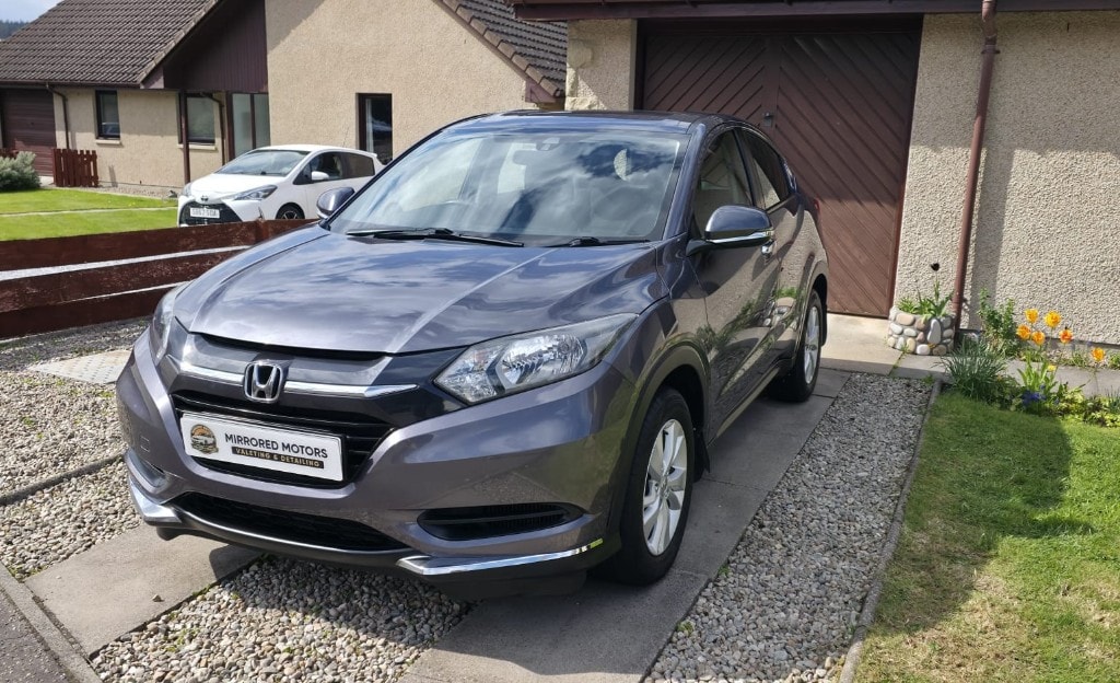 Freshly detailed grey Honda on a driveway with Mirrored Motors plate