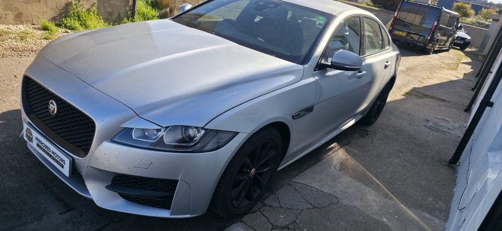 Silver Jaguar XF cleaned inside and out on the driveway