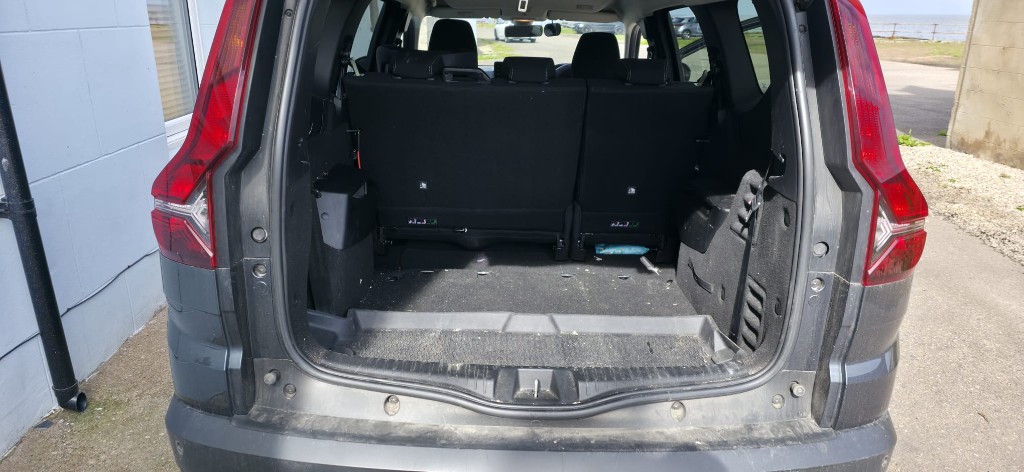 Dirty boot and load area with debris before cleaning